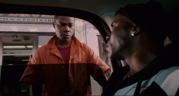 Movie still from “First Sunday” (2008), directed by David E. Talbert – Two men in a car looking at each other; Medium shot, Over the shoulder angle