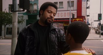 Movie still from “First Sunday” (2008), directed by David E. Talbert – A man standing next to another man on the street; Close Up shot, Over the shoulder angle