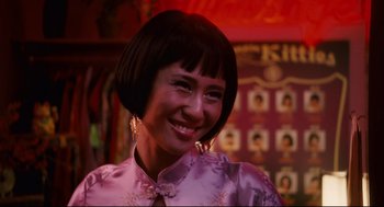 Movie still from “First Sunday” (2008), directed by David E. Talbert – A woman in a purple dress smiling for the camera; Close Up shot, Over the shoulder angle