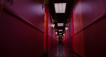Movie still from “First Sunday” (2008), directed by David E. Talbert – A long hallway with red walls in a building; Wide shot, Low angle
