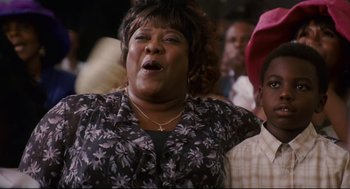 Movie still from “First Sunday” (2008), directed by David E. Talbert – An older woman sings in front of an audience; Close Up shot, Low angle