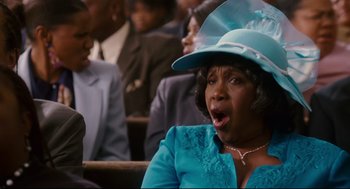 Movie still from “First Sunday” (2008), directed by David E. Talbert – A woman in a blue dress and a blue hat; Close Up shot, Low angle