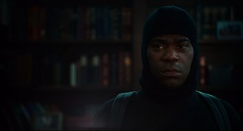 Movie still from “First Sunday” (2008), directed by David E. Talbert – A man wearing a black hooded sweatshirt and a black backpack; Close Up shot, Low angle