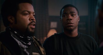 Movie still from “First Sunday” (2008), directed by David E. Talbert – Two men standing next to each other in a dark room; Close Up shot, Over the shoulder angle