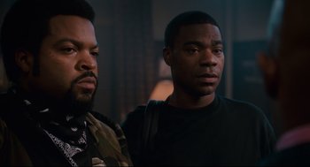 Movie still from “First Sunday” (2008), directed by David E. Talbert – Two men standing next to each other in a dark room; Close Up shot, Over the shoulder angle