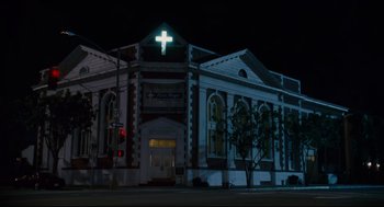 Movie still from “First Sunday” (2008), directed by David E. Talbert – A building that has a cross on the top of the building; Extreme Wide shot, Low angle