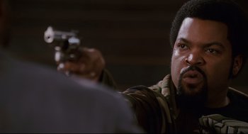 Movie still from “First Sunday” (2008), directed by David E. Talbert – A person holding a gun; Close Up shot, Over the shoulder angle