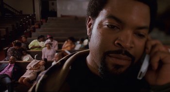 Movie still from “First Sunday” (2008), directed by David E. Talbert – A person with a beard in front of other people; Close Up shot, Overhead angle