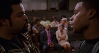 Movie still from “First Sunday” (2008), directed by David E. Talbert – Two men are facing each other in front of a group of people; Close Up shot, Over the shoulder angle