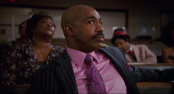 Movie still from “First Sunday” (2008), directed by David E. Talbert – A man in a pink shirt and a pink tie; Medium shot, Low angle