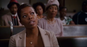 Movie still from “First Sunday” (2008), directed by David E. Talbert – A woman sitting in front of a group of other women; Close Up shot, Over the shoulder angle