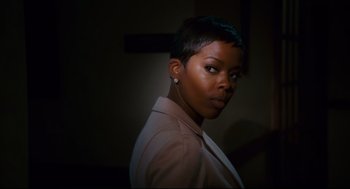 Movie still from “First Sunday” (2008), directed by David E. Talbert – A woman with short black hair wearing a jacket; Close Up shot, Over the shoulder angle