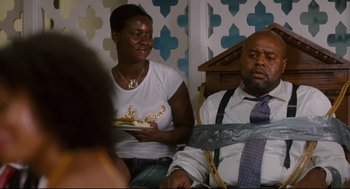 Movie still from “First Sunday” (2008), directed by David E. Talbert – A man and a woman sitting next to each other; Medium shot, Over the shoulder angle