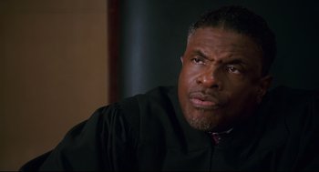 Movie still from “First Sunday” (2008), directed by David E. Talbert – A man in a judge's robe looking into the distance; Close Up shot, Low angle