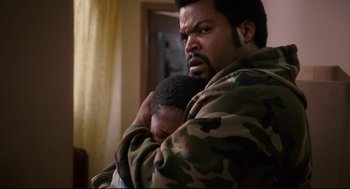 Movie still from “First Sunday” (2008), directed by David E. Talbert – A man hugging another man with his arms wrapped around him; Close Up shot, Over the shoulder angle