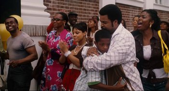 Movie still from “First Sunday” (2008), directed by David E. Talbert – A group of people standing next to each other in front of a brick wall; Medium shot, Over the shoulder angle