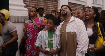 Movie still from “First Sunday” (2008), directed by David E. Talbert – A group of people standing around each other; Medium shot, Over the shoulder angle