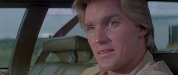 Movie still from “Flash Gordon” (1980), directed by Mike Hodges – A man's face in the back of a car; Close Up shot, Low angle