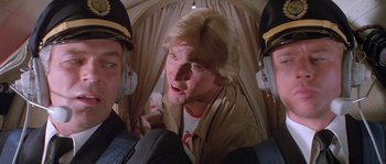Movie still from “Flash Gordon” (1980), directed by Mike Hodges – A man in a helicopter with two other men; Close Up shot, Low angle