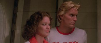 Movie still from “Flash Gordon” (1980), directed by Mike Hodges – A woman and a man sitting next to each other in a room; Close Up shot, Low angle