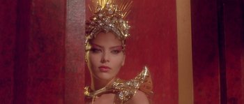 Movie still from “Flash Gordon” (1980), directed by Mike Hodges – A woman wearing a gold headpiece and a gold necklace; Close Up shot, Low angle