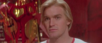 Movie still from “Flash Gordon” (1980), directed by Mike Hodges – A person with blond hair; Close Up shot, Low angle