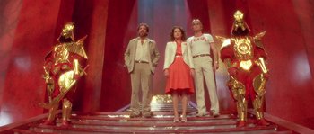 Movie still from “Flash Gordon” (1980), directed by Mike Hodges – A group of people standing on some steps; Wide shot, Low angle