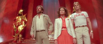 Movie still from “Flash Gordon” (1980), directed by Mike Hodges – A man and a woman standing next to each other; Medium shot, Low angle