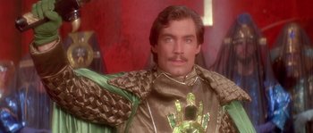 Movie still from “Flash Gordon” (1980), directed by Mike Hodges – A person wearing a costume; Close Up shot, Over the shoulder angle