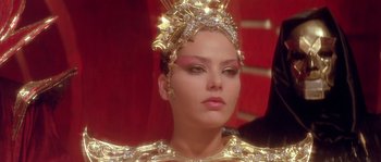 Movie still from “Flash Gordon” (1980), directed by Mike Hodges – A person wearing a costume; Close Up shot, Over the shoulder angle