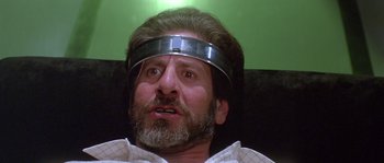 Movie still from “Flash Gordon” (1980), directed by Mike Hodges – A man with a beard wearing a metal head piece; Close Up shot, Low angle