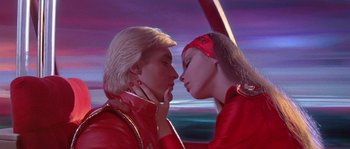 Movie still from “Flash Gordon” (1980), directed by Mike Hodges – A man and a woman kissing each other; Close Up shot, Low angle