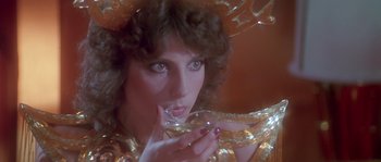 Movie still from “Flash Gordon” (1980), directed by Mike Hodges – A person holding a wine glass; Close Up shot, Low angle