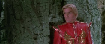 Movie still from “Flash Gordon” (1980), directed by Mike Hodges – A man in a red and gold outfit; Close Up shot, Low angle