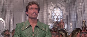 Movie still from “Flash Gordon” (1980), directed by Mike Hodges – A person wearing a green shirt; Close Up shot, Low angle