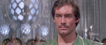 Movie still from “Flash Gordon” (1980), directed by Mike Hodges – A person with a mustache; Close Up shot, Low angle