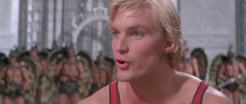 Movie still from “Flash Gordon” (1980), directed by Mike Hodges – A person with blond hair; Close Up shot, Low angle