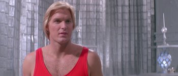 Movie still from “Flash Gordon” (1980), directed by Mike Hodges – A person wearing a red shirt; Close Up shot, Low angle