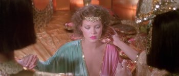 Movie still from “Flash Gordon” (1980), directed by Mike Hodges – A woman is putting makeup on her face; Close Up shot, Over the shoulder angle