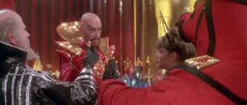 Movie still from “Flash Gordon” (1980), directed by Mike Hodges – A man and a woman dressed in costumes; Medium shot, Over the shoulder angle