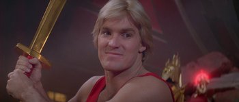 Movie still from “Flash Gordon” (1980), directed by Mike Hodges – A person wearing a red shirt; Close Up shot, Low angle
