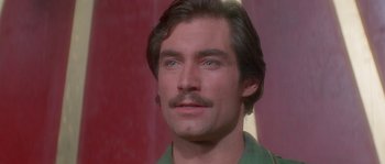 Movie still from “Flash Gordon” (1980), directed by Mike Hodges – A person wearing a green shirt; Close Up shot, Low angle