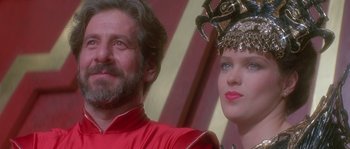 Movie still from “Flash Gordon” (1980), directed by Mike Hodges – A man and a woman are standing next to each other; Close Up shot, Low angle