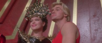 Movie still from “Flash Gordon” (1980), directed by Mike Hodges – A man and a woman standing next to each other; Close Up shot, Low angle