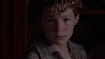 Movie still from “Flesh and Bone” (1993), directed by Steve Kloves – A young boy is looking into the camera; Close Up shot, Low angle