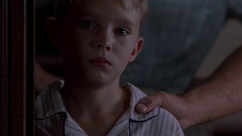Movie still from “Flesh and Bone” (1993), directed by Steve Kloves – A person with a child; Close Up shot, Low angle