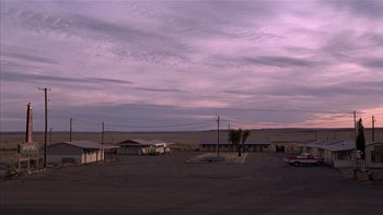 Movie still from “Flesh and Bone” (1993), directed by Steve Kloves – An empty parking lot in the middle of a desert; Extreme Wide shot, High angle