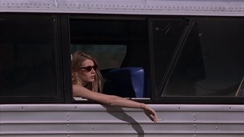Movie still from “Flesh and Bone” (1993), directed by Steve Kloves – A woman sitting in the window of a bus; Medium shot, Low angle