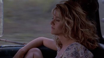 Movie still from “Flesh and Bone” (1993), directed by Steve Kloves – A woman sitting in a car with her head resting on her arm; Close Up shot, Low angle