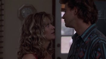 Movie still from “Flesh and Bone” (1993), directed by Steve Kloves – A man and a woman standing next to each other in a room; Close Up shot, Over the shoulder angle
